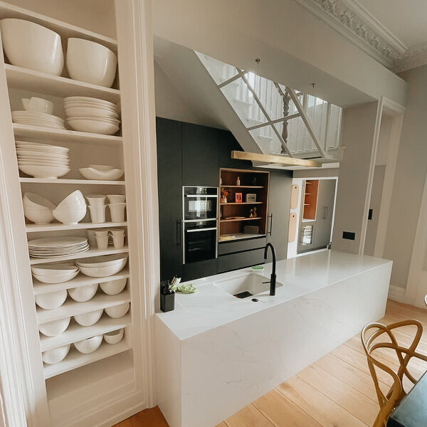 Englefield: a kitchen with open crockery shelves and a pale stone island